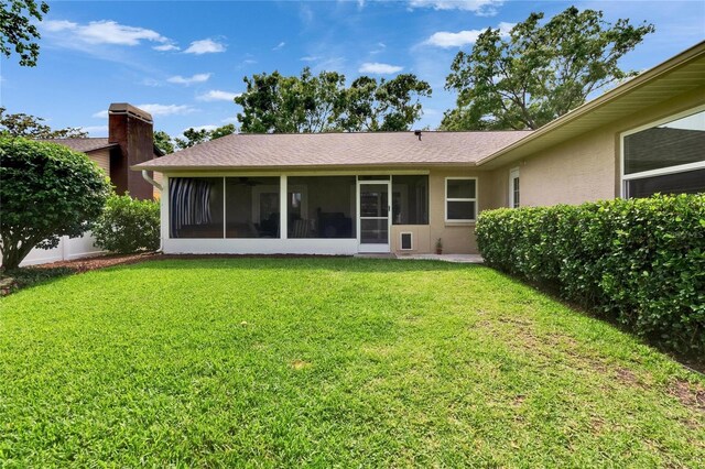 905 Balsamina Dr, Brandon, FL 33510 - back of house with a sunroom, a lawn, ceiling fan, and stucco siding