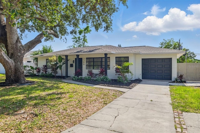 3300 52nd St N, Saint Petersburg, FL 33710 - single story home featuring a garage, concrete driveway, and covered porch