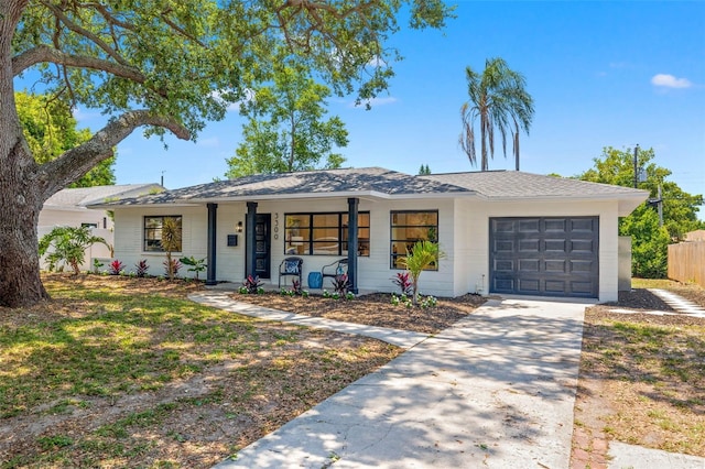 3300 52nd St N, Saint Petersburg, FL 33710 - view of front of house featuring an attached garage, driveway, and covered porch