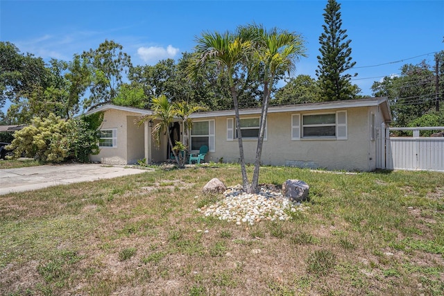 11486 92nd St N, Largo, FL 33773 - ranch-style house with stucco siding and a front lawn