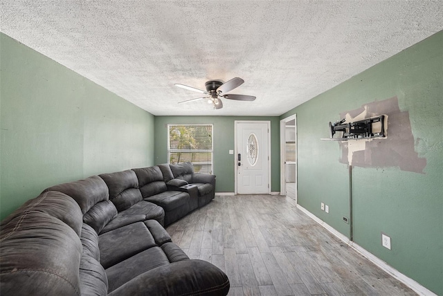 11486 92nd St N, Largo, FL 33773 - living room with a ceiling fan, a textured ceiling, wood finished floors, and baseboards