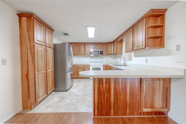 12220 Twin Branch Acres Rd, Tampa, FL 33626 - kitchen with stainless steel appliances, a sink, a peninsula, light countertops, and open shelves
