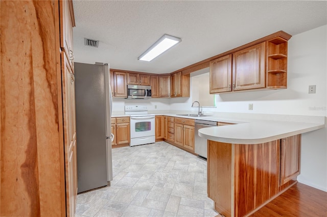12220 Twin Branch Acres Rd, Tampa, FL 33626 - kitchen featuring stainless steel appliances, a sink, a peninsula, light countertops, and open shelves