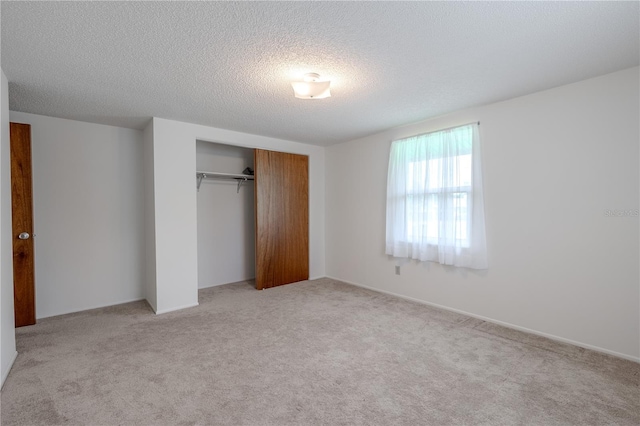 12220 Twin Branch Acres Rd, Tampa, FL 33626 - unfurnished bedroom featuring light carpet, a closet, and a textured ceiling