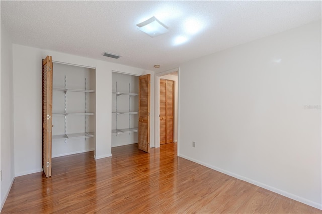 12220 Twin Branch Acres Rd, Tampa, FL 33626 - unfurnished bedroom with a closet, light wood finished floors, and baseboards