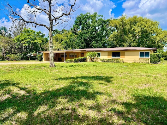10308 Fore Dr, Tampa, FL 33612 - ranch-style house with a front lawn, an attached carport, and stucco siding
