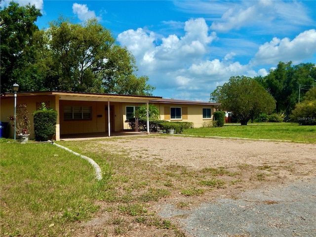 10308 Fore Dr, Tampa, FL 33612 - view of front of house featuring driveway, a carport, and a front yard