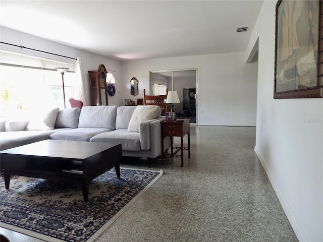 10308 Fore Dr, Tampa, FL 33612 - living area with speckle patterned floor and baseboards