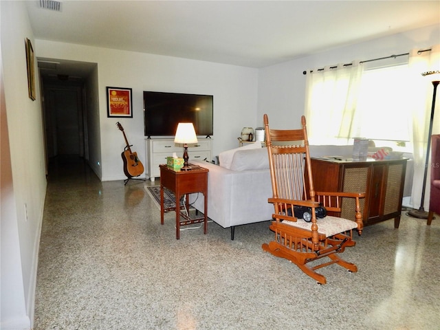 10308 Fore Dr, Tampa, FL 33612 - living area with speckle patterned floor and baseboards