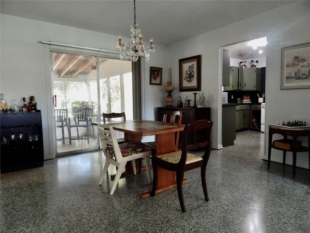 10308 Fore Dr, Tampa, FL 33612 - dining area featuring light speckled floor and a chandelier
