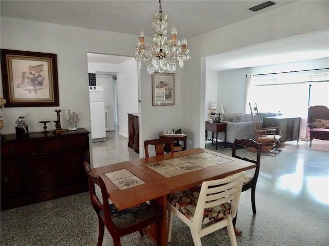 10308 Fore Dr, Tampa, FL 33612 - dining room with a chandelier and speckled floor