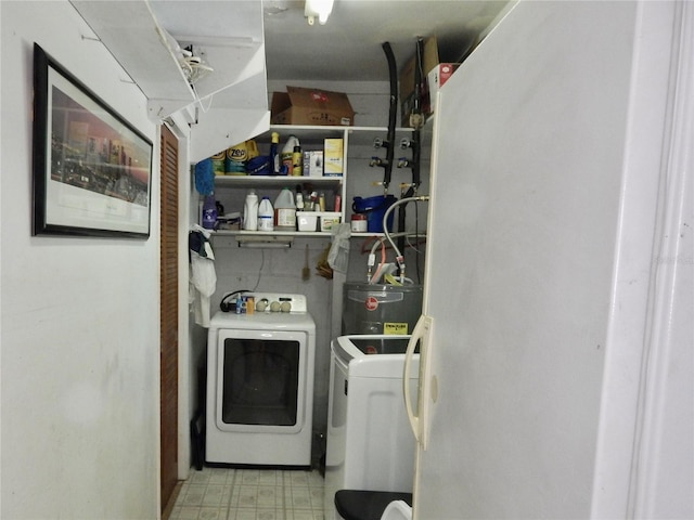 10308 Fore Dr, Tampa, FL 33612 - washroom featuring washer and clothes dryer, electric water heater, and tile patterned floors