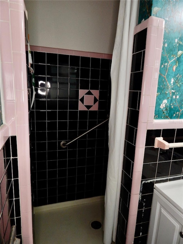10308 Fore Dr, Tampa, FL 33612 - bathroom with a stall shower, tile walls, and vanity