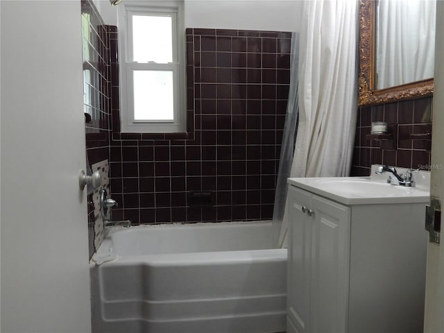 10308 Fore Dr, Tampa, FL 33612 - bathroom with shower / bath combo, vanity, and tile walls