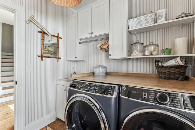 3405 W Palmira Ave, Tampa, FL 33629 - laundry area featuring separate washer and dryer, cabinet space, and wallpapered walls