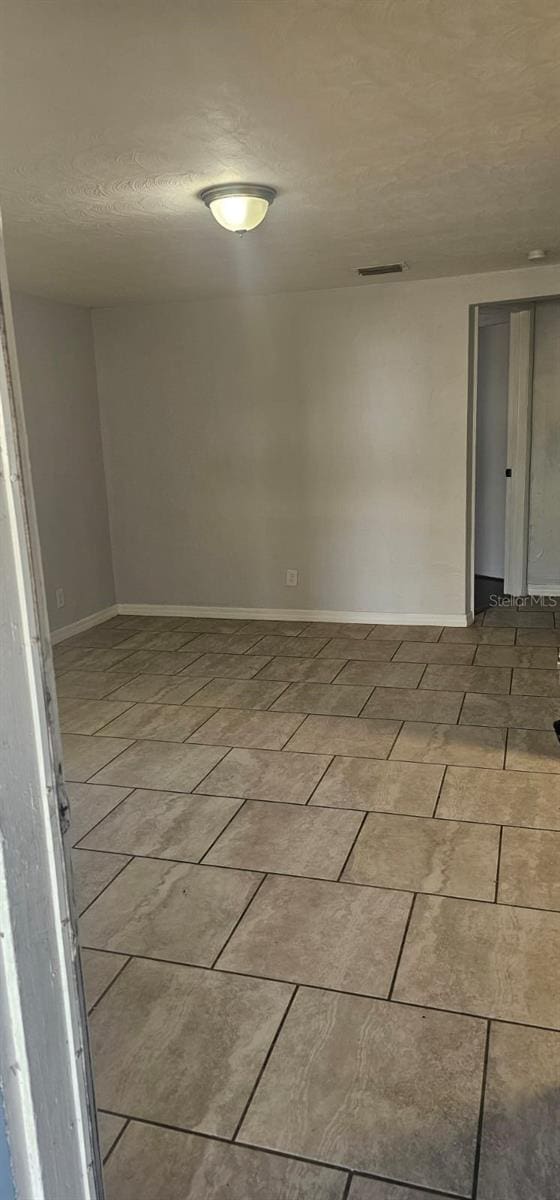 9307 N 16th St, Tampa, FL 33612 - spare room featuring baseboards