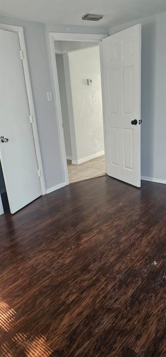 9307 N 16th St, Tampa, FL 33612 - spare room with wood finished floors and baseboards