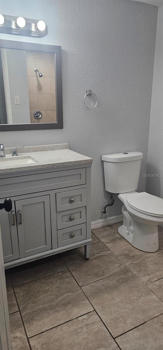 9307 N 16th St, Tampa, FL 33612 - full bathroom with toilet, tile patterned floors, and vanity