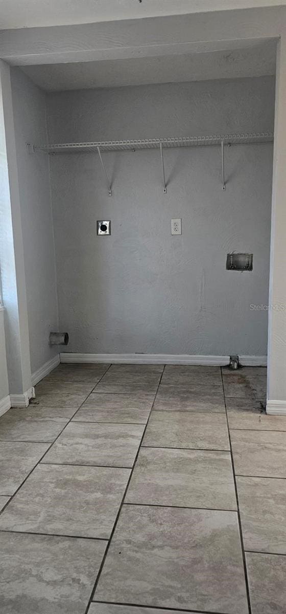 9307 N 16th St, Tampa, FL 33612 - laundry area with baseboards, tile patterned flooring, and hookup for a washing machine