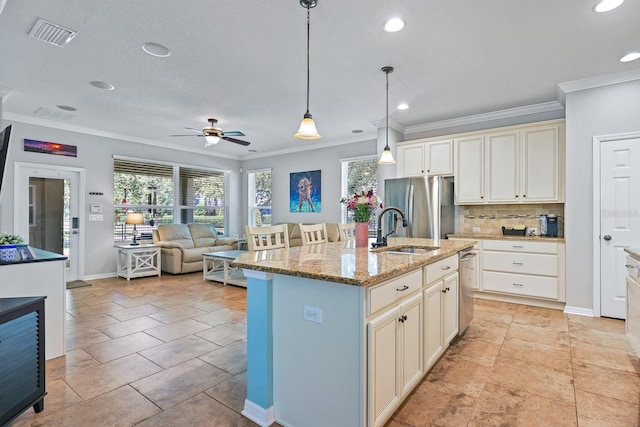 5401 Match Point Pl, Lithia, FL 33547 - kitchen featuring stainless steel fridge, crown molding, a sink, plenty of natural light, and decorative backsplash