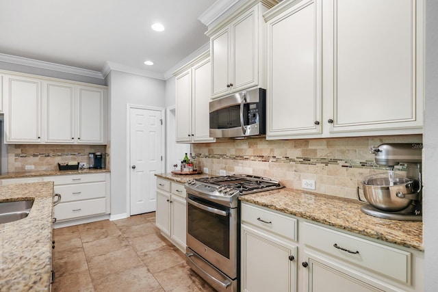 5401 Match Point Pl, Lithia, FL 33547 - kitchen with stainless steel appliances, ornamental molding, tasteful backsplash, light stone countertops, and recessed lighting