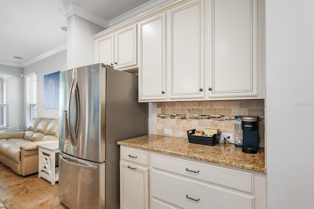 5401 Match Point Pl, Lithia, FL 33547 - kitchen with stainless steel refrigerator with ice dispenser, crown molding, backsplash, open floor plan, and light stone countertops