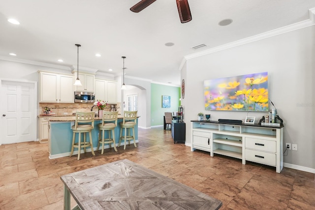 5401 Match Point Pl, Lithia, FL 33547 - living room with arched walkways, ornamental molding, a ceiling fan, baseboards, and recessed lighting