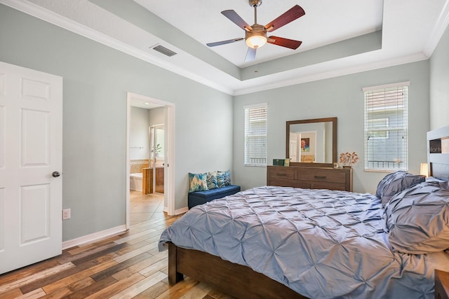 5401 Match Point Pl, Lithia, FL 33547 - bedroom featuring hardwood / wood-style flooring, a raised ceiling, baseboards, ornamental molding, and ensuite bath