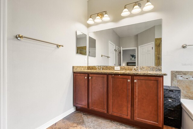 5401 Match Point Pl, Lithia, FL 33547 - bathroom featuring double vanity, baseboards, and a tile shower
