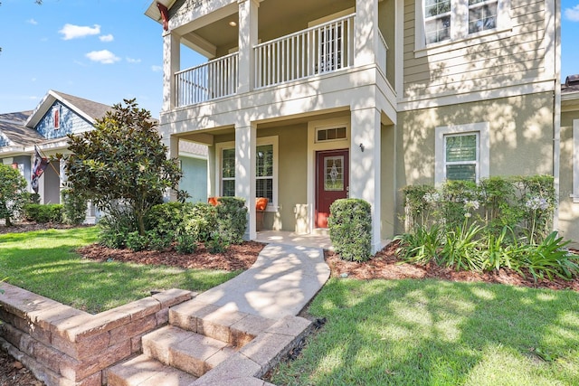 5401 Match Point Pl, Lithia, FL 33547 - view of exterior entry with a balcony, stucco siding, and a lawn