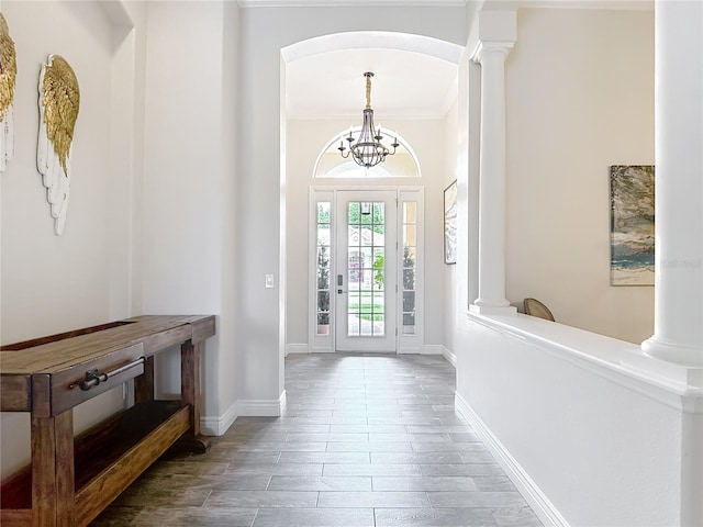 1443 Obear Ct, Wesley Chapel, FL 33543 - entrance foyer featuring a chandelier, ornate columns, baseboards, ornamental molding, and wood finished floors