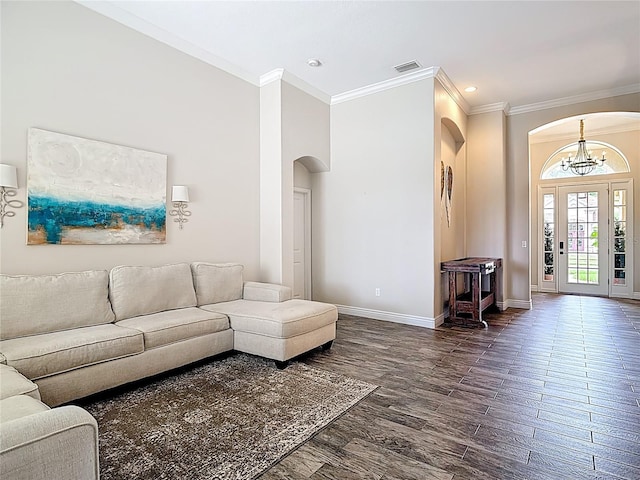 1443 Obear Ct, Wesley Chapel, FL 33543 - living room with arched walkways, ornamental molding, baseboards, a chandelier, and dark wood finished floors