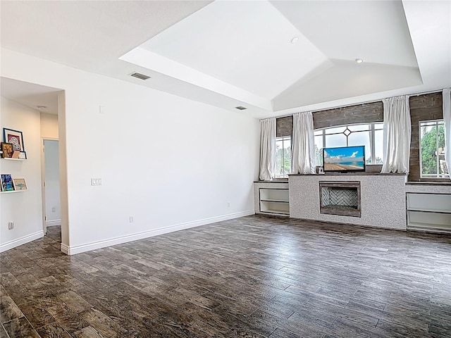 1443 Obear Ct, Wesley Chapel, FL 33543 - unfurnished living room featuring dark wood-style flooring, plenty of natural light, vaulted ceiling, and baseboards