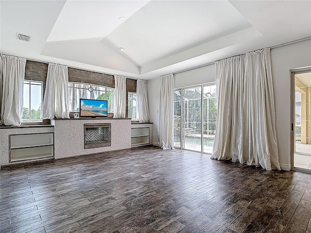 1443 Obear Ct, Wesley Chapel, FL 33543 - unfurnished living room with dark wood-type flooring, lofted ceiling, and a tray ceiling