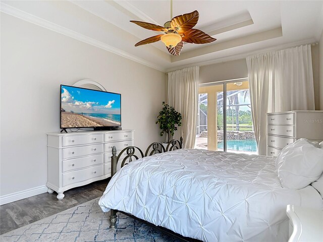 1443 Obear Ct, Wesley Chapel, FL 33543 - bedroom featuring a raised ceiling, access to exterior, wood finished floors, baseboards, and a ceiling fan