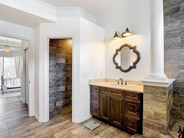 1443 Obear Ct, Wesley Chapel, FL 33543 - bathroom with wood finished floors, vanity, ensuite bath, tiled shower, and decorative columns