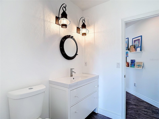 1443 Obear Ct, Wesley Chapel, FL 33543 - bathroom with vanity, toilet, wood finished floors, and baseboards