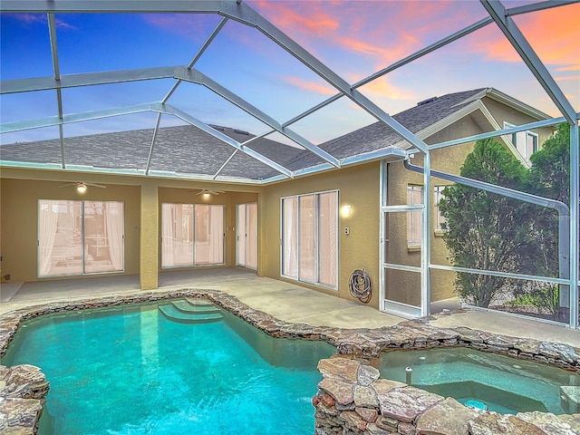 1443 Obear Ct, Wesley Chapel, FL 33543 - pool at dusk with an outdoor pool, ceiling fan, an in-ground hot tub, and a patio area