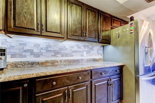 700 Starkey Rd Unit 1216, Largo, FL 33771 - kitchen featuring stainless steel fridge, light countertops, backsplash, and dark brown cabinets