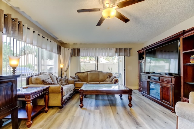 700 Starkey Rd Unit 1216, Largo, FL 33771 - living area with ceiling fan, light wood finished floors, and a textured ceiling