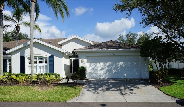 2325 Brookfield Greens Cir Unit 41, Sun City Center, FL 33573 - ranch-style house with an attached garage, stucco siding, concrete driveway, and a shingled roof