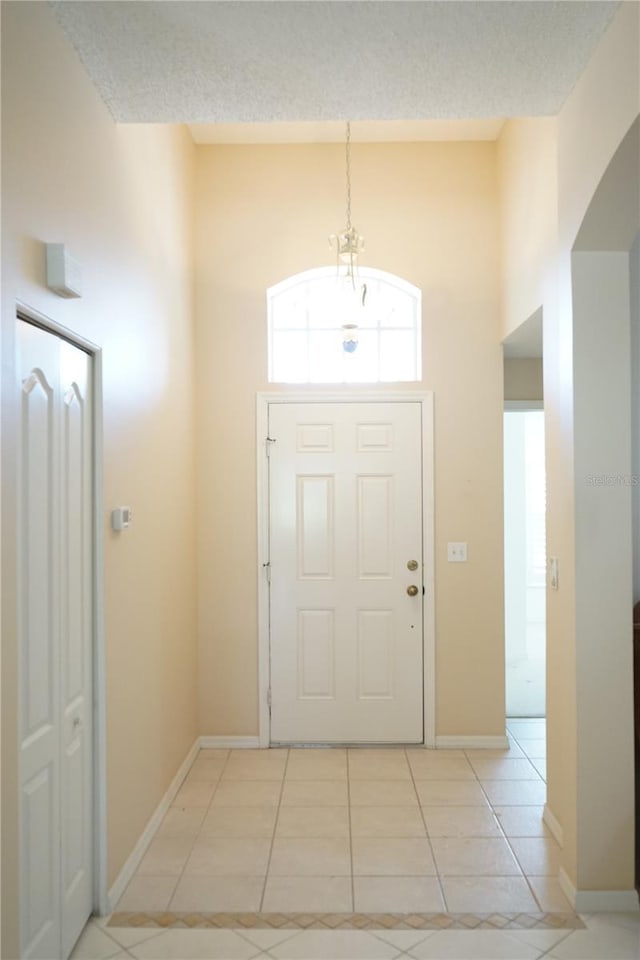 2325 Brookfield Greens Cir Unit 41, Sun City Center, FL 33573 - entrance foyer featuring light tile patterned flooring, baseboards, and a textured ceiling