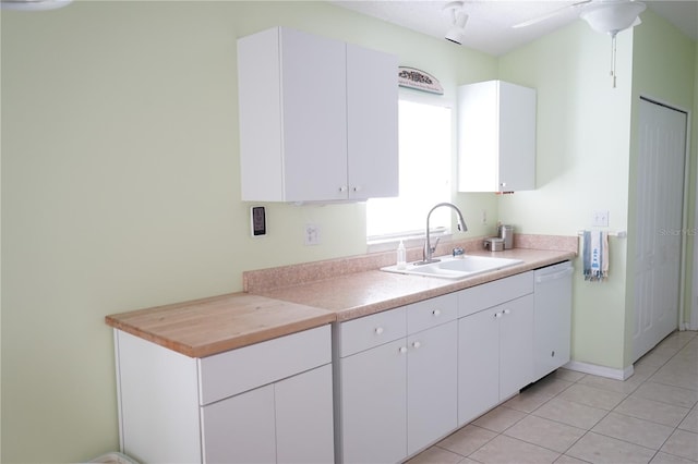2325 Brookfield Greens Cir Unit 41, Sun City Center, FL 33573 - kitchen with a sink, white dishwasher, light countertops, light tile patterned flooring, and white cabinets