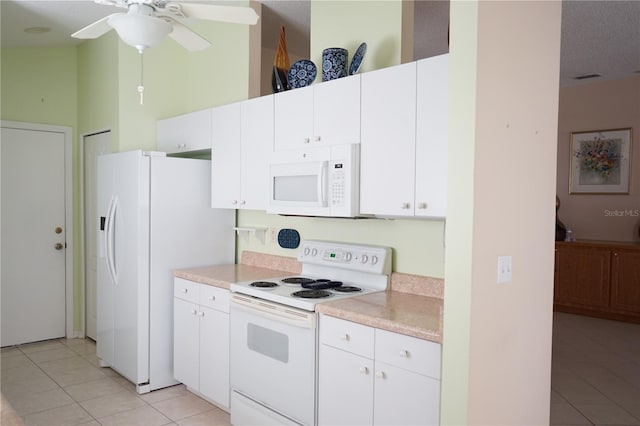 2325 Brookfield Greens Cir Unit 41, Sun City Center, FL 33573 - kitchen with white appliances, light tile patterned floors, light countertops, and white cabinets