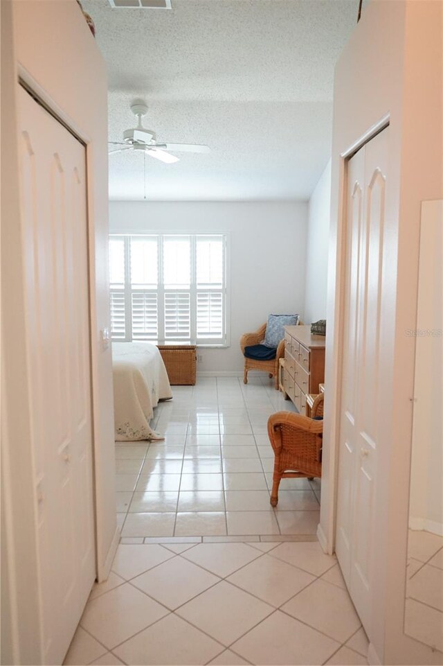 2325 Brookfield Greens Cir Unit 41, Sun City Center, FL 33573 - bedroom with light tile patterned floors, ceiling fan, and baseboards