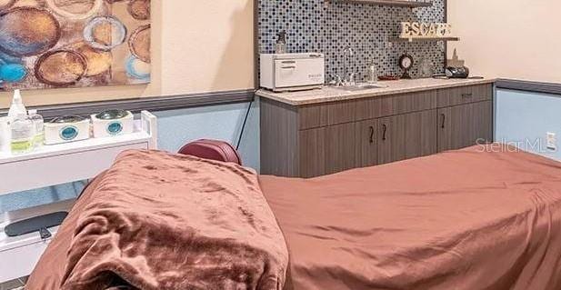 2325 Brookfield Greens Cir Unit 41, Sun City Center, FL 33573 - bedroom featuring a sink