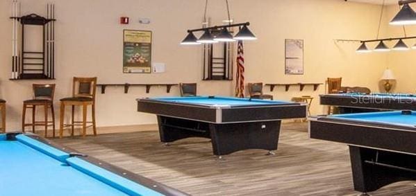 2325 Brookfield Greens Cir Unit 41, Sun City Center, FL 33573 - rec room with pool table, baseboards, and wood finished floors