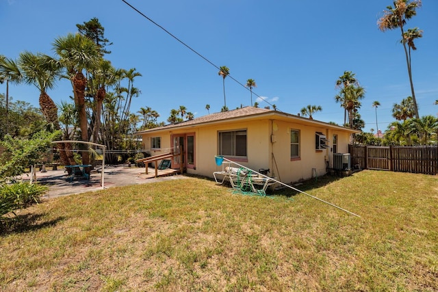 3111 S De Bazan Ave, St Pete Beach, FL 33706 - rear view of house featuring a patio area, stucco siding, and central AC