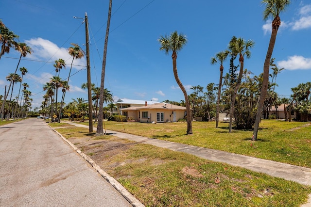 3111 S De Bazan Ave, St Pete Beach, FL 33706 - view of front facade featuring a front lawn