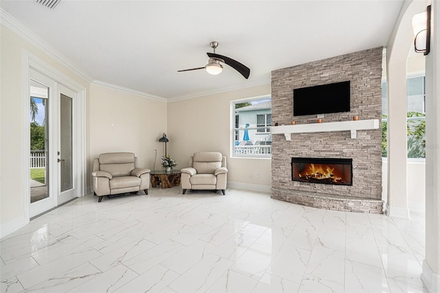4353 Dewey Dr, New Port Richey, FL 34652 - living room featuring baseboards, marble look tiles, a ceiling fan, a stone fireplace, and ornamental molding